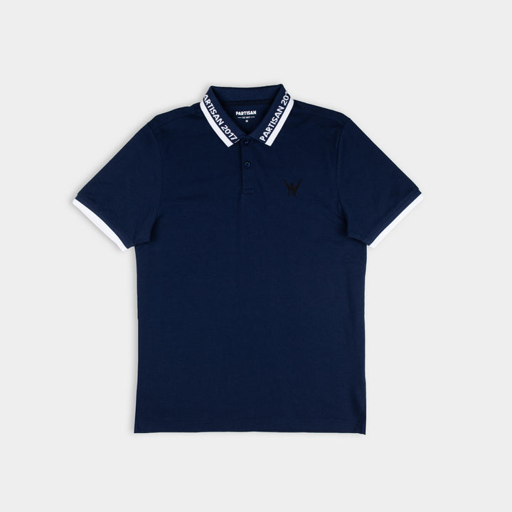 Partisan 2017 Polo in Sprink Navy — contrast collar, woven branding and embossed chest emblem on dark navy piqué