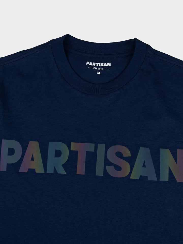 Partisan Reflective Print Tee in Navy Blue – close-up detail of the light-shifting multicolour reflective chest logo on navy streetwear t-shirt by Partisan and Co