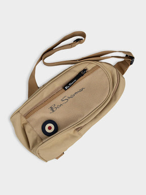 Ben Sherman Satchel Crossbody Bag in New Wheat with multiple compartments, mesh pocket, adjustable strap and Mod target emblem – front view
