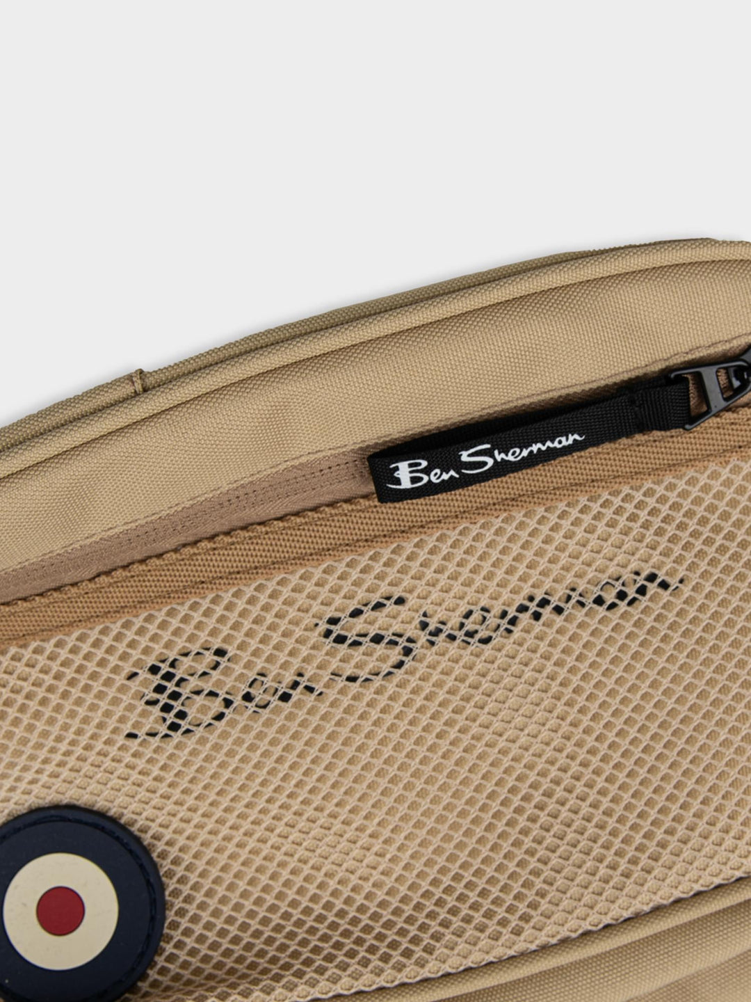 Close-up top view of Ben Sherman Satchel Crossbody in New Wheat showing front mesh pocket, zip closure and Ben Sherman logo detail