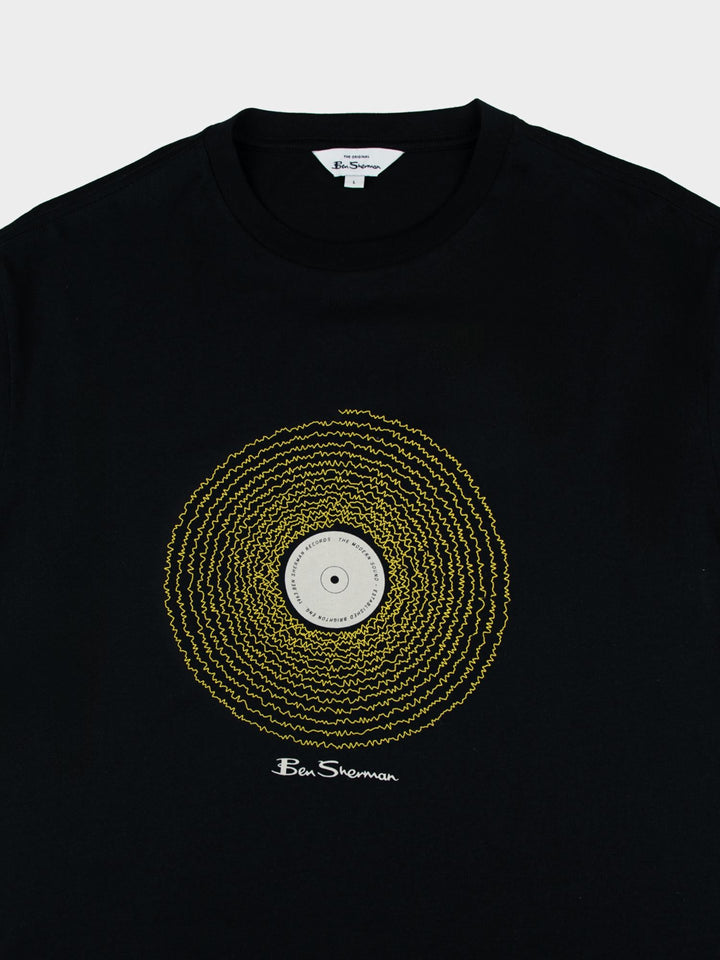 Ben Sherman Sound Wave Graphic T-Shirt in Black – close-up flat lay of bold gold vinyl record chest print with Ben Sherman signature on black cotton