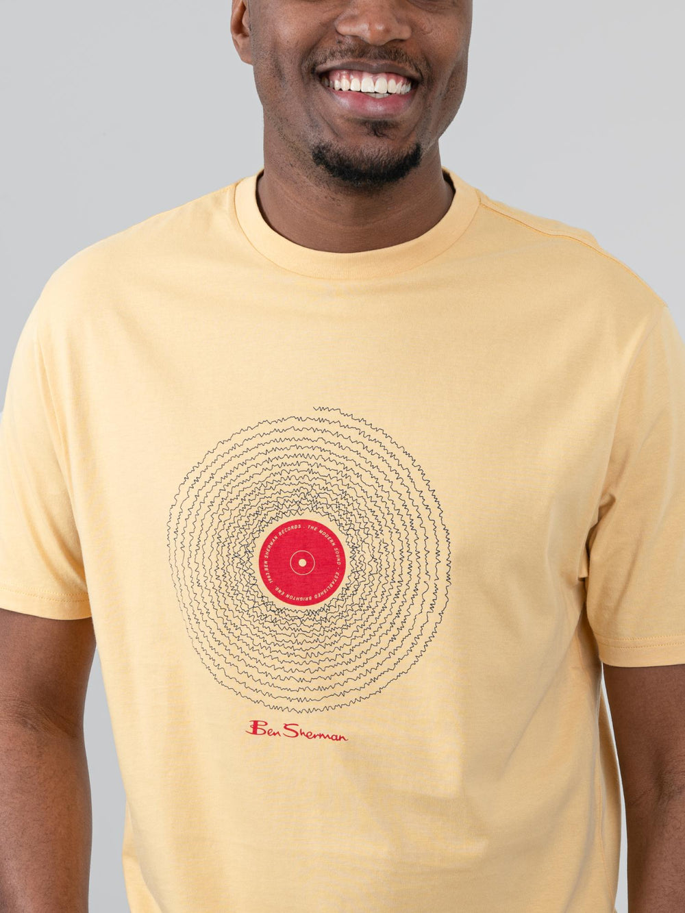 Close-up of Ben Sherman Sound Wave Graphic Tee in New Wheat – detailed vinyl record chest print with Ben Sherman signature on warm wheat cotton