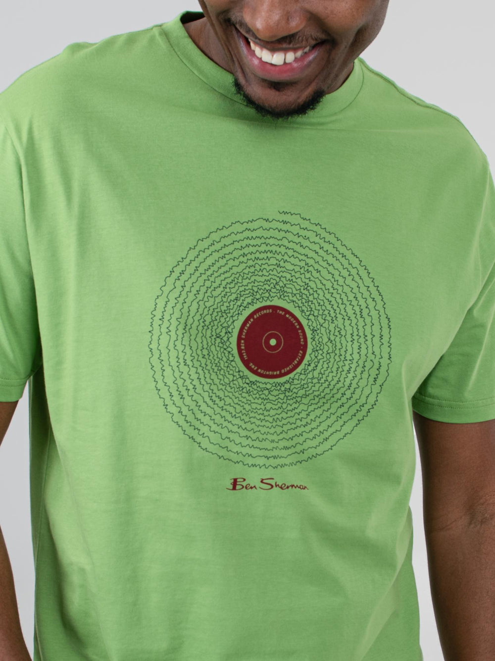 Close-up of Ben Sherman Sound Wave Graphic Tee in Piquant Green – detailed vinyl record chest print with signature Ben Sherman logo on green cotton