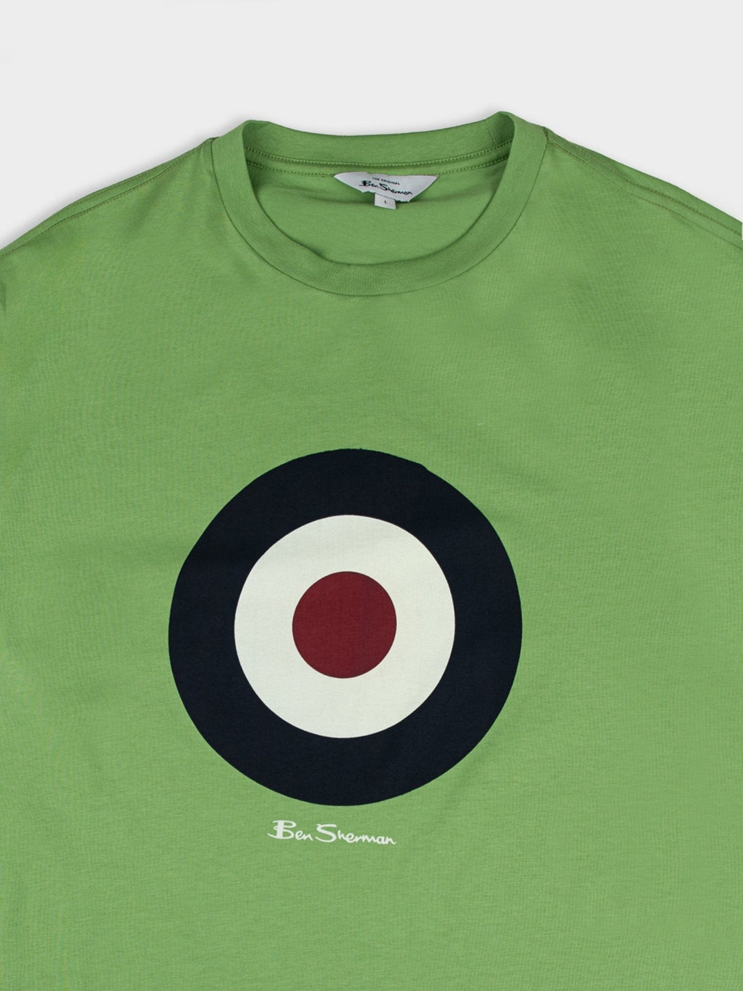 Detail shot of Ben Sherman target chest logo and crewneck collar on Piquant Green organic cotton t-shirt