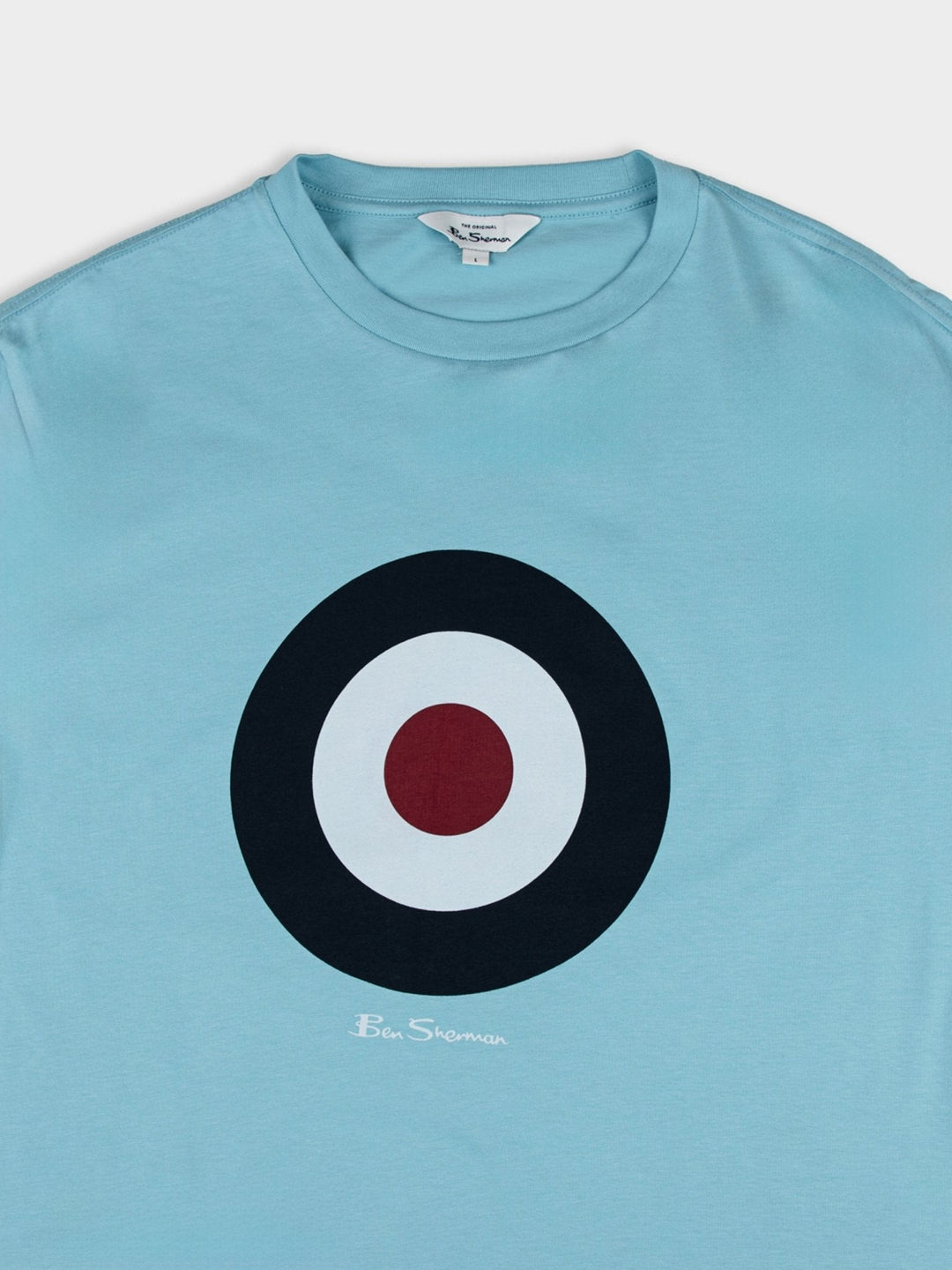 Detail shot of Ben Sherman target chest logo and crewneck collar on Retro Blue organic cotton t-shirt