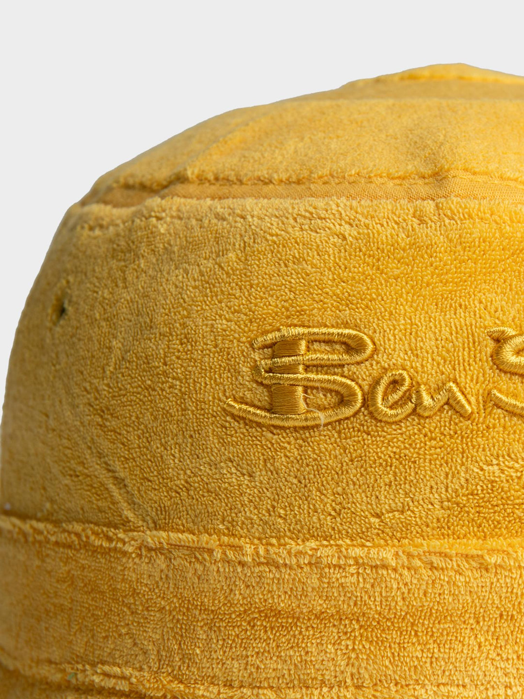 Ben Sherman Target Towelling Bucket Hat in Banana - close-up of tonal embroidered Ben Sherman logo on soft yellow terrycloth