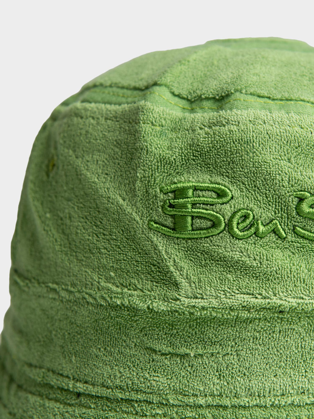 Ben Sherman Target Towelling Bucket Hat in Piquant Green - close-up of tonal embroidered Ben Sherman logo on soft green terrycloth