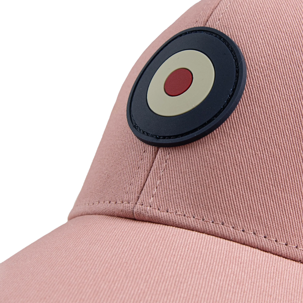 Close-up of rubber Target emblem patch on Ben Sherman Targy Peak Cap in Light Pink