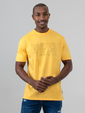 Ben Sherman Trio Embossed Bears graphic T-shirt in Banana yellow, worn by a smiling male model on a light grey background