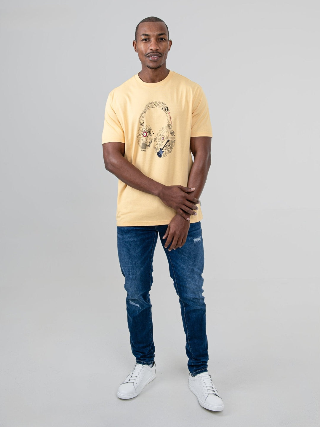 aBen Sherman Typography Headphones Tee New Wheat - full-length front view on model, regular fit wheat tee with headphone graphic, styled with jeans