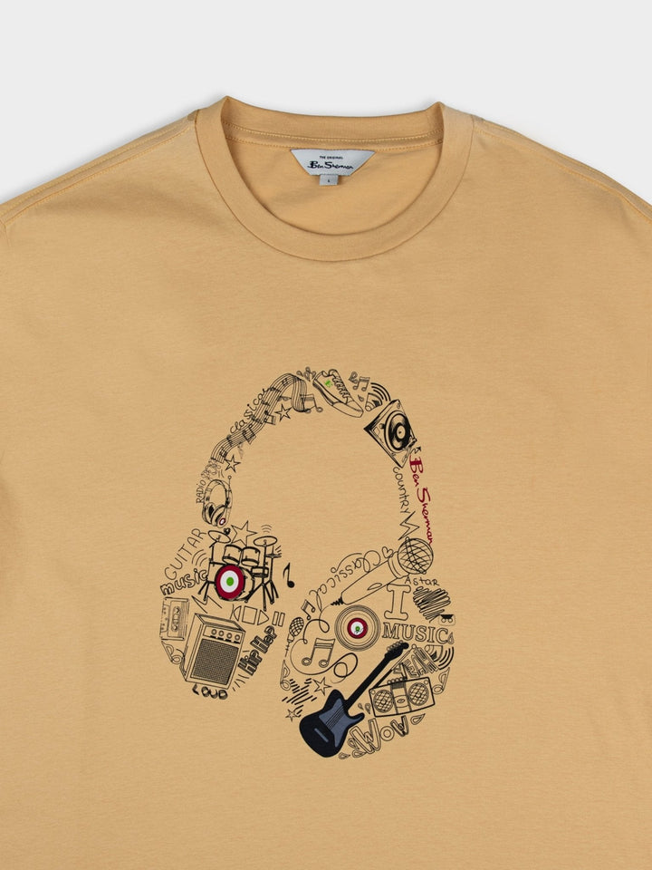 aBen Sherman Typography Headphones Tee New Wheat - overhead close-up of headphone graphic detail with music icons on wheat cotton fabric