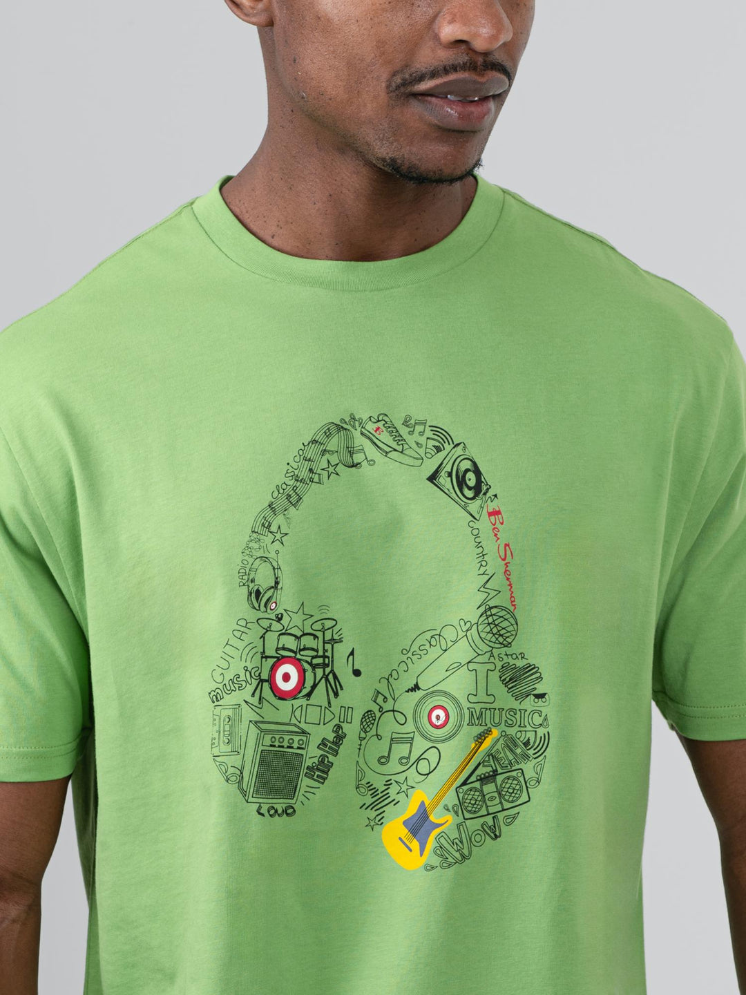 Close-up of Ben Sherman Typography Headphones graphic print on Piquant Green cotton tee