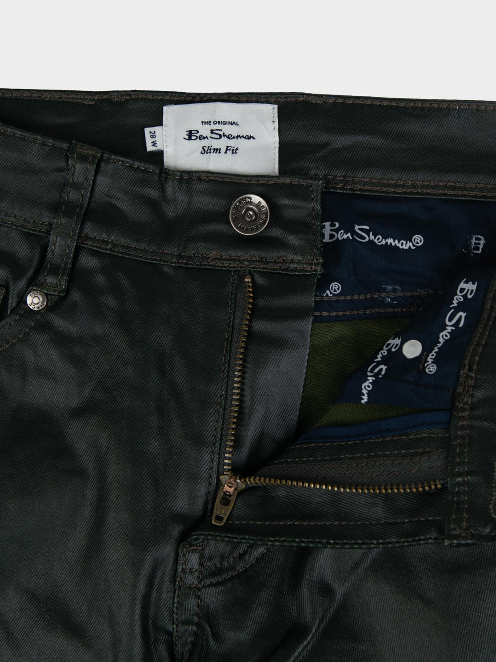 Ben Sherman Wax Coated Sheen Slim Fit Denim in Olive - close-up detail of Ben Sherman branded label, zip fly and button fastening with wax-sheen finish