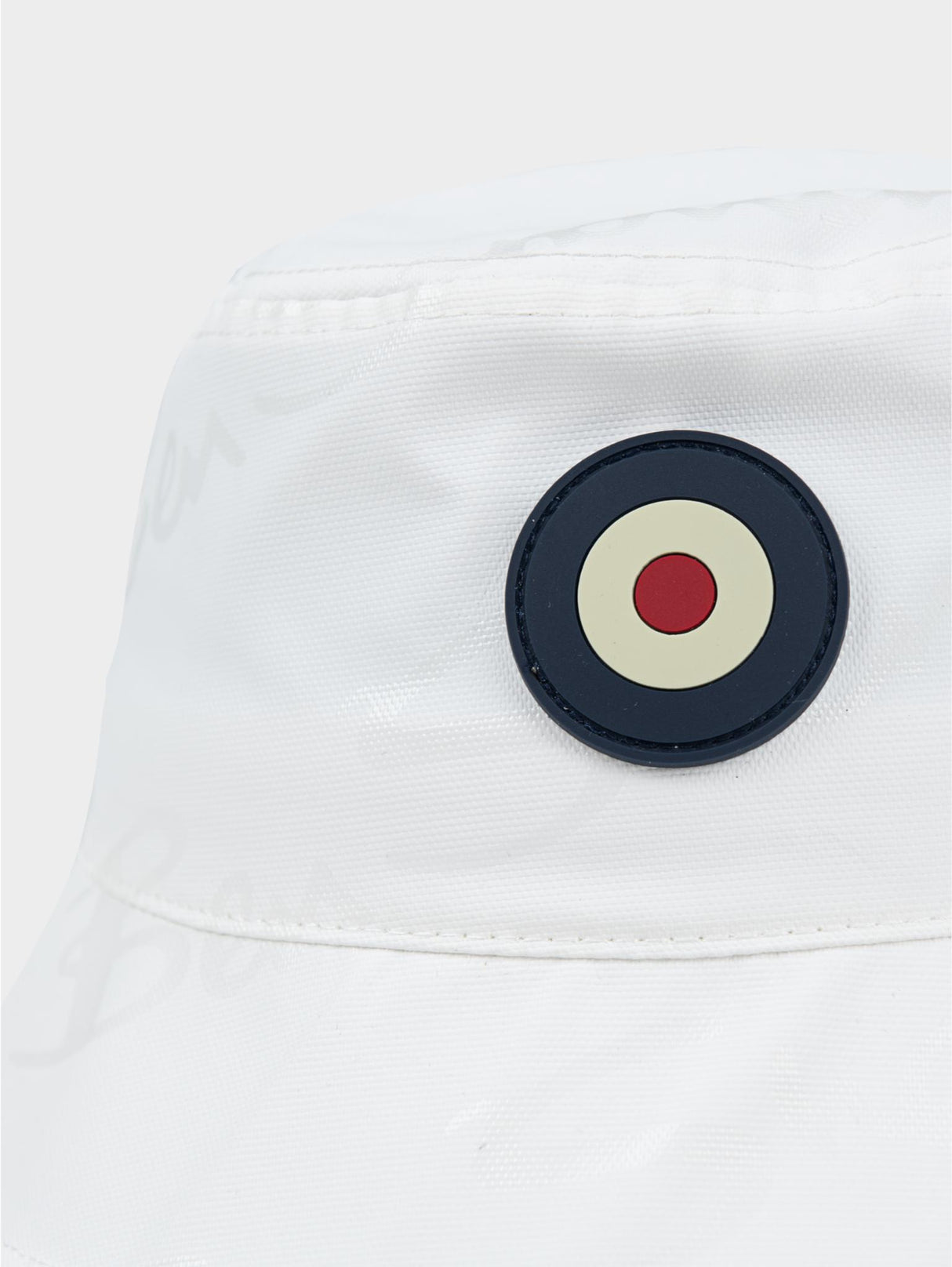 Ben Sherman bucket hat in White – close-up of embroidered target logo on the reversible interior lining