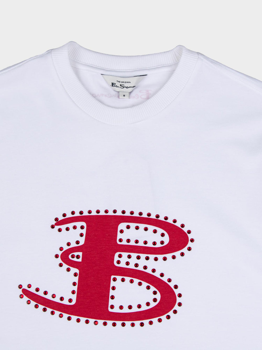 Ben Sherman B Bling Tee in White - close-up detail of oversized rhinestone-studded B logo graphic on white cotton tee with Ben Sherman branded crew neckline